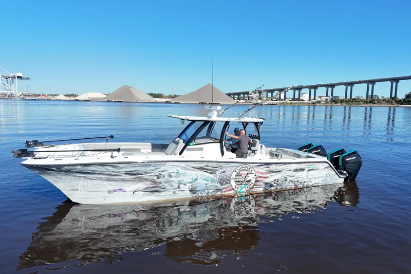  Yacht Photos Pics 2024 Front Runner 37 Catamaran on calm water, featuring vibrant graphics and dual outboard engines.