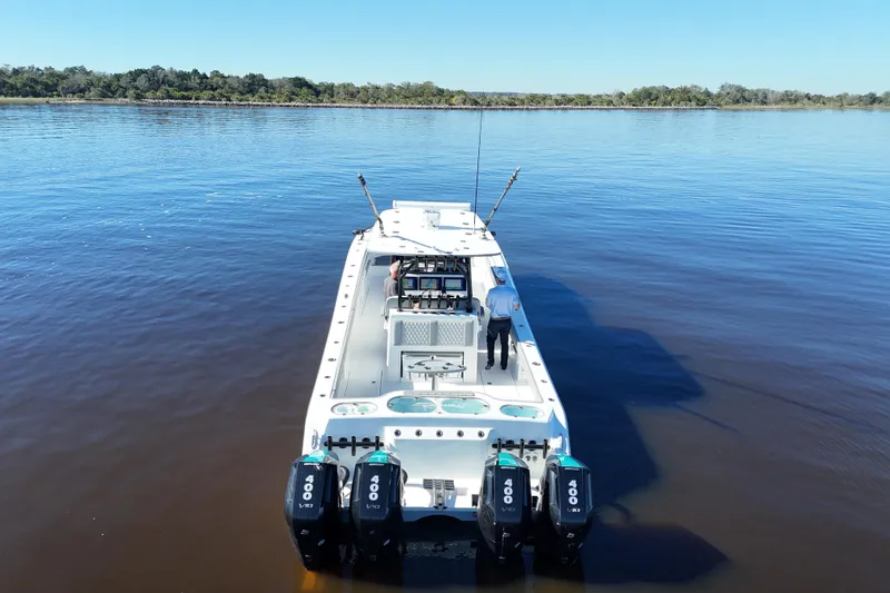  Yacht Photos Pics 2024 Front Runner 37 Catamaran on calm water, featuring four powerful outboard engines.