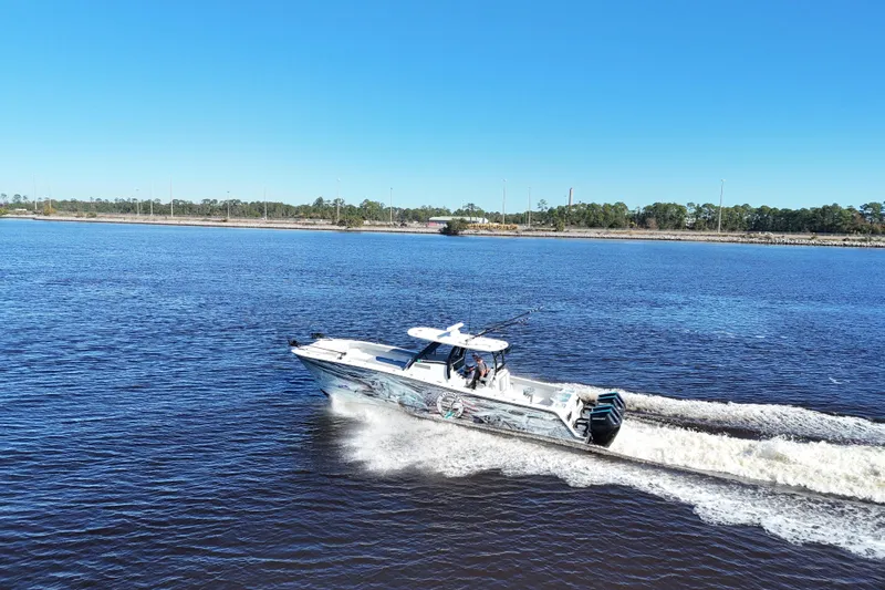  Yacht Photos Pics 2024 Front Runner 37 Catamaran cruising on a sunny day, creating a wake in the water.
