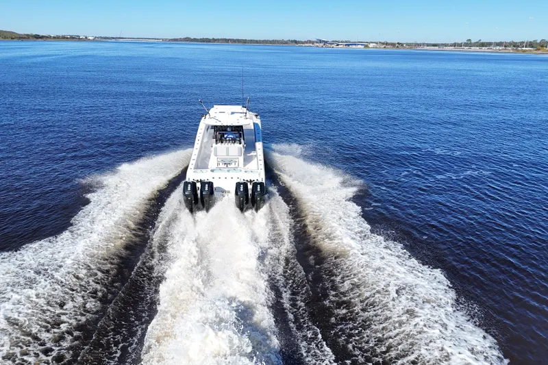  Yacht Photos Pics 2024 Front Runner 37 Catamaran cruising on open water, leaving a wake behind.