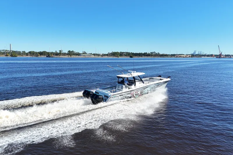  Yacht Photos Pics 2024 Front Runner 37 Catamaran cruising on a sunny day, showcasing sleek design and powerful engines.