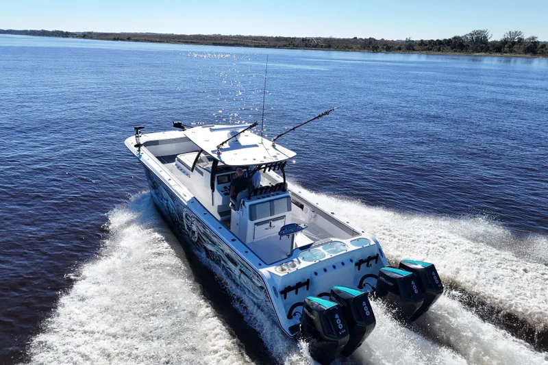  Yacht Photos Pics 2024 Front Runner 37 Catamaran cruising on open water with triple outboard engines.