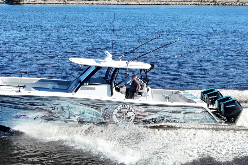  Yacht Photos Pics 2024 Front Runner 37 Catamaran cruising on water with vibrant fishing-themed graphics.