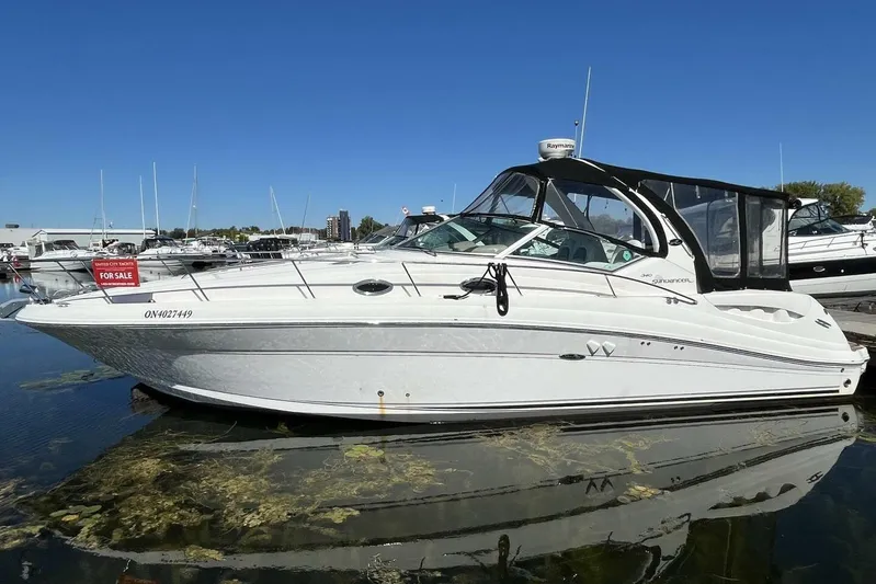  Yacht Photos Pics 2007 Sea Ray 340 Sundancer boat for sale, docked in marina under clear blue sky.