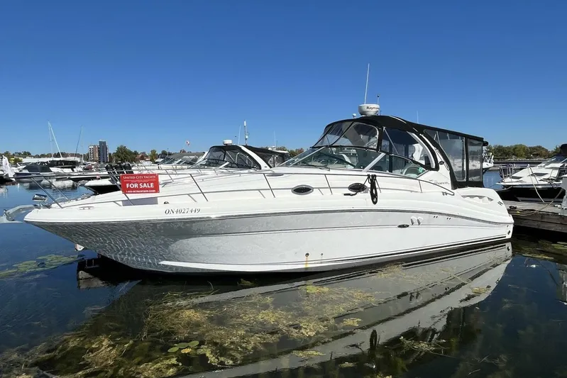  Yacht Photos Pics 2007 Sea Ray 340 Sundancer yacht for sale, docked in marina under clear blue sky.
