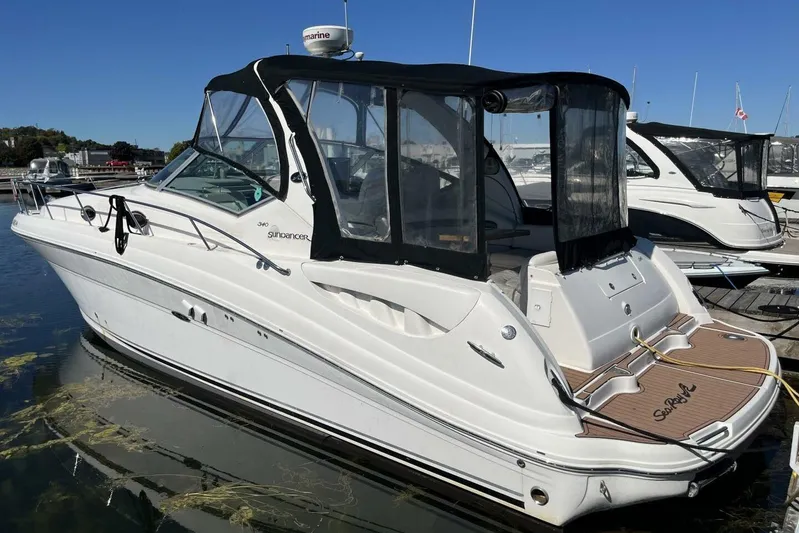  Yacht Photos Pics 2007 Sea Ray 340 Sundancer boat docked at marina, featuring sleek design and black canopy.