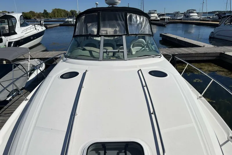  Yacht Photos Pics 2007 Sea Ray 340 Sundancer docked at marina, showcasing sleek design and spacious deck.