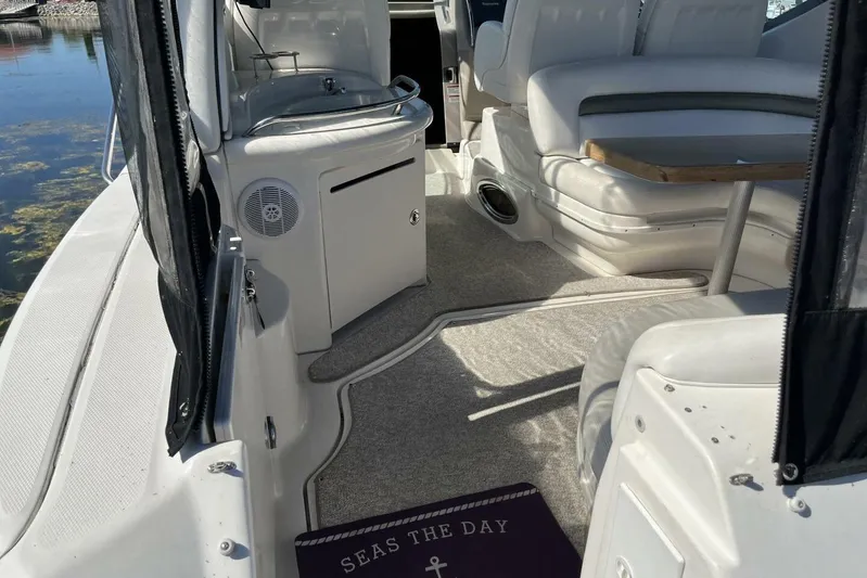  Yacht Photos Pics 2007 Sea Ray 340 Sundancer interior with seating, table, and "Seas the Day" mat.