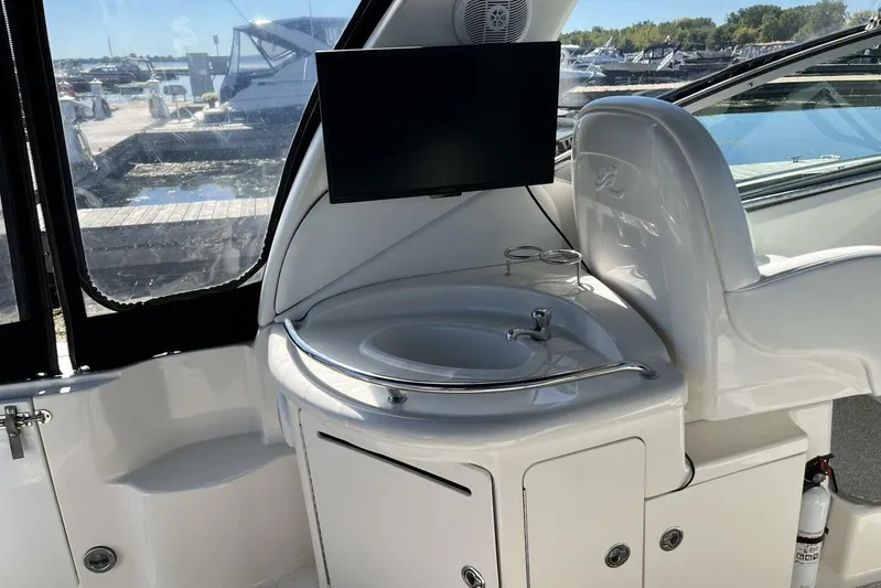  Yacht Photos Pics 2007 Sea Ray 340 Sundancer interior with sink, TV, and marina view.
