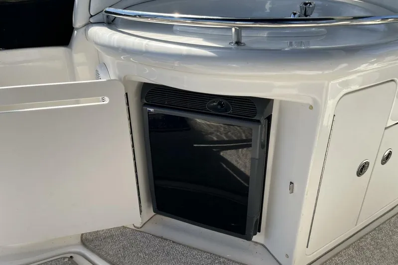  Yacht Photos Pics 2007 Sea Ray 340 Sundancer boat interior with open cabinet and mini fridge.
