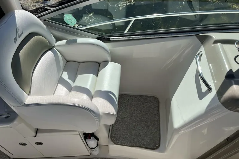  Yacht Photos Pics Captain's seat on 2007 Sea Ray 340 Sundancer boat, featuring white upholstery and helm controls.