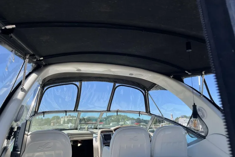  Yacht Photos Pics Interior view of 2007 Sea Ray 340 Sundancer boat with clear canopy and white seating.