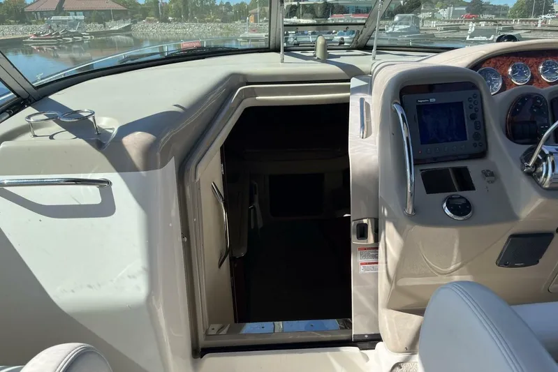  Yacht Photos Pics 2007 Sea Ray 340 Sundancer cockpit with navigation controls and cabin entrance.