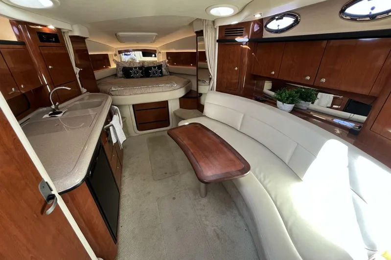  Yacht Photos Pics Luxurious interior of 2007 Sea Ray 340 Sundancer yacht with elegant seating and kitchenette.