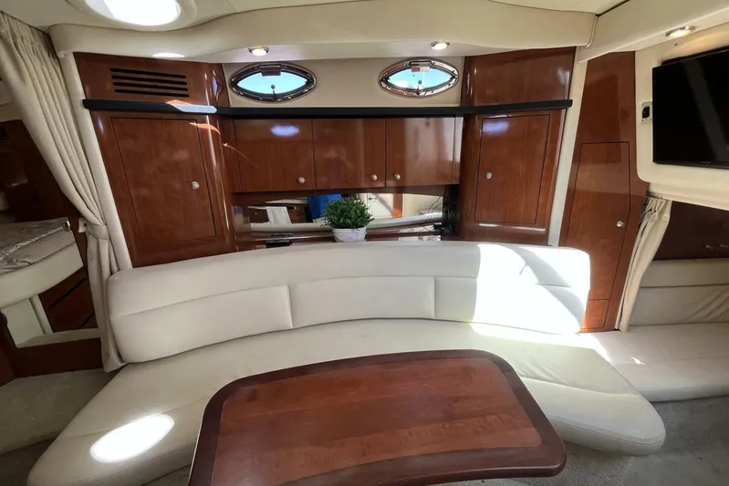  Yacht Photos Pics Luxurious interior of 2007 Sea Ray 340 Sundancer with elegant wood cabinetry and plush seating.