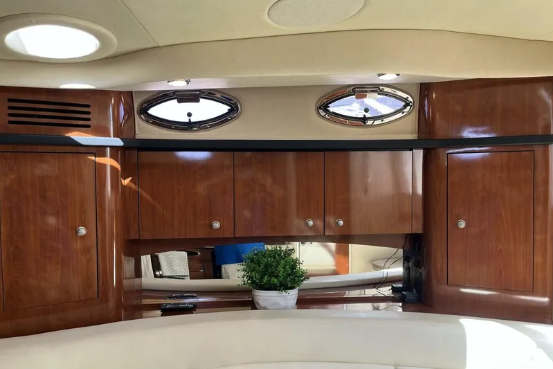  Yacht Photos Pics Luxurious interior of 2007 Sea Ray 340 Sundancer with wood cabinets and porthole windows.