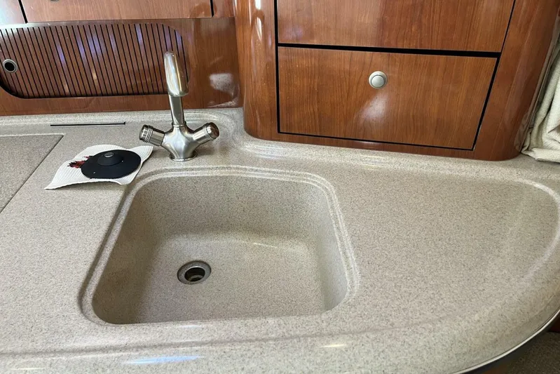  Yacht Photos Pics 2007 Sea Ray 340 Sundancer kitchen sink with wooden cabinetry and modern faucet.