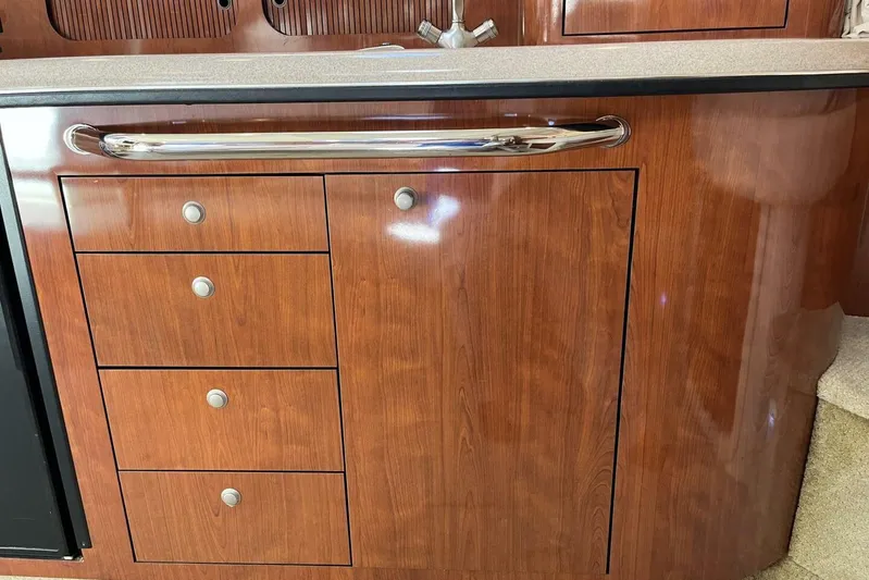  Yacht Photos Pics 2007 Sea Ray 340 Sundancer interior with wooden cabinetry and stainless steel handle.