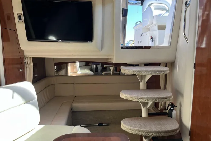  Yacht Photos Pics Interior of 2007 Sea Ray 340 Sundancer yacht with TV, seating, and carpeted stairs.