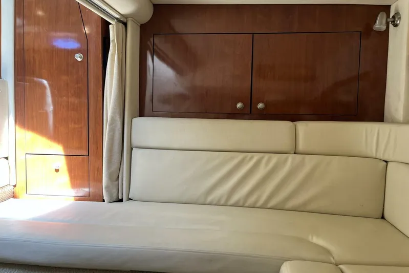  Yacht Photos Pics Interior of 2007 Sea Ray 340 Sundancer with cream leather seating and wooden cabinetry.