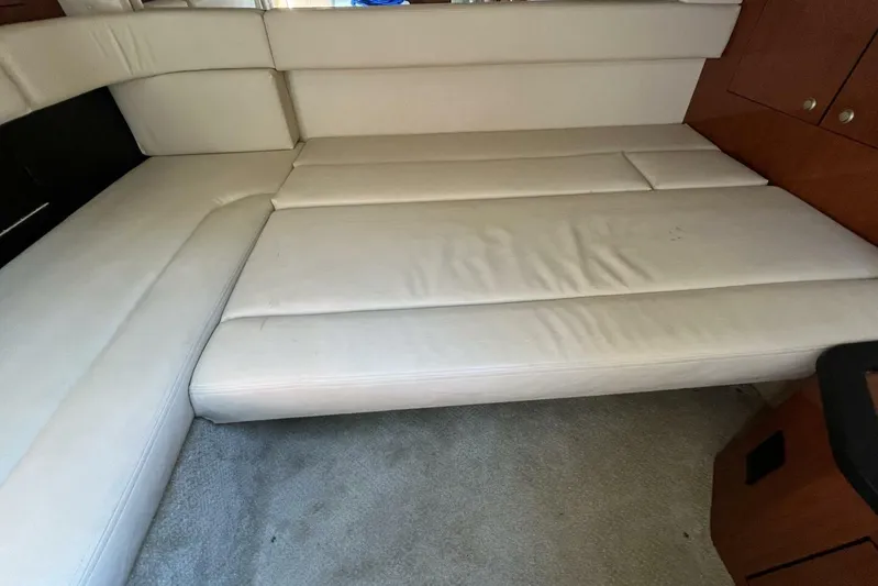  Yacht Photos Pics 2007 Sea Ray 340 Sundancer interior with white leather seating and wooden cabinetry.