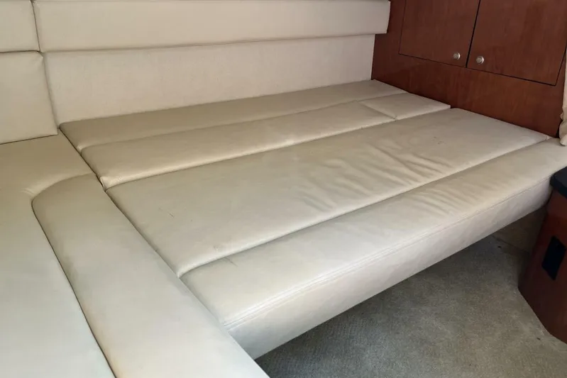  Yacht Photos Pics Interior seating of 2007 Sea Ray 340 Sundancer with beige upholstery and wooden cabinetry.