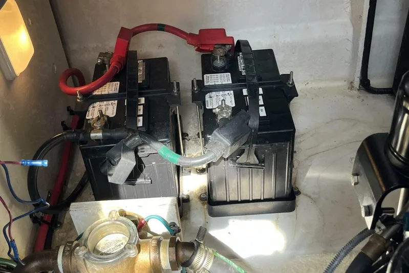  Yacht Photos Pics Battery compartment of a 2007 Sea Ray 340 Sundancer boat, showing two batteries and wiring.