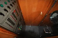 Electrical control panel inside 2010 Trader 64 Sunliner yacht with wooden interior.