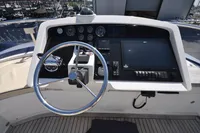 Steering console of 2010 Trader 64 Sunliner yacht with gauges and navigation controls.