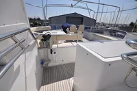 2010 Trader 64 Sunliner yacht deck with seating and marina view.