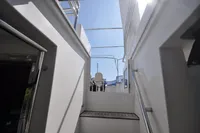 Stairway view on 2010 Trader 64 Sunliner yacht under clear blue sky.