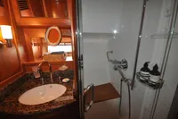 Luxurious bathroom in 2010 Trader 64 Sunliner yacht with granite sink and glass shower.