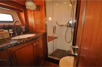 Luxurious bathroom in 2010 Trader 64 Sunliner yacht with wood accents and modern fixtures.