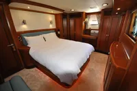 Luxurious cabin interior of 2010 Trader 64 Sunliner yacht with elegant wood finishes.