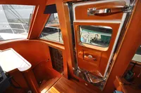 Interior of 2010 Trader 64 Sunliner yacht with wooden finish and door details.