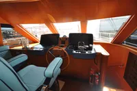 Interior of 2010 Trader 64 Sunliner yacht helm with modern controls and seating.