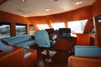 Luxurious interior of 2010 Trader 64 Sunliner yacht with elegant seating and helm station.