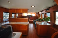 Luxurious interior of 2010 Trader 64 Sunliner yacht with wood finishes and modern amenities.