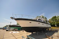 Trader 64 Sunliner 2010 yacht on dry dock under clear blue sky.