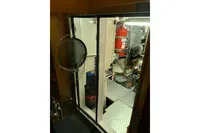 Engine room of 2010 Trader 64 Sunliner with fire extinguisher and equipment.