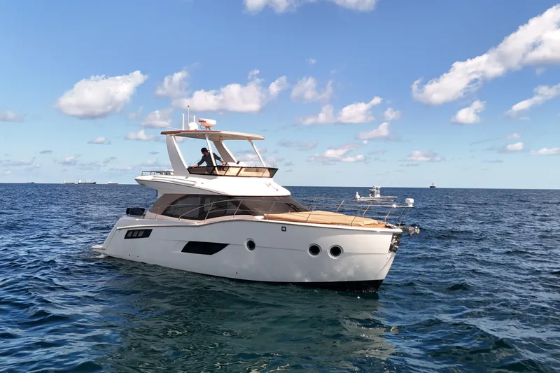  Yacht Photos Pics 2014 Carver 40 Command Bridge yacht cruising on open sea under blue sky.