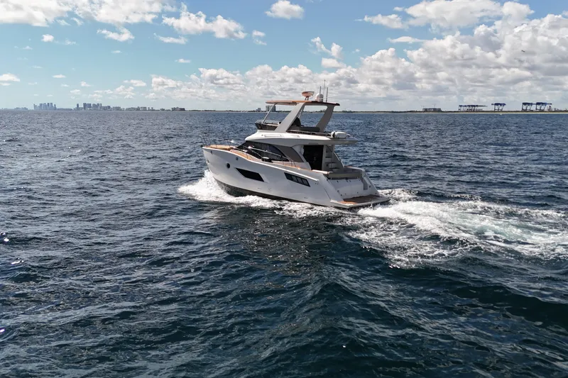  Yacht Photos Pics 2014 Carver 40 Command Bridge yacht cruising on open water under a partly cloudy sky.
