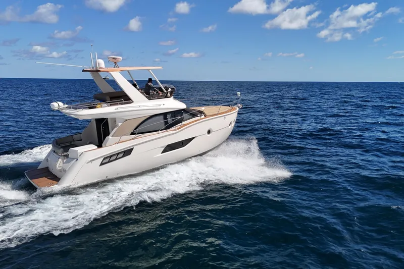  Yacht Photos Pics 2014 Carver 40 Command Bridge yacht cruising on open ocean under clear skies.