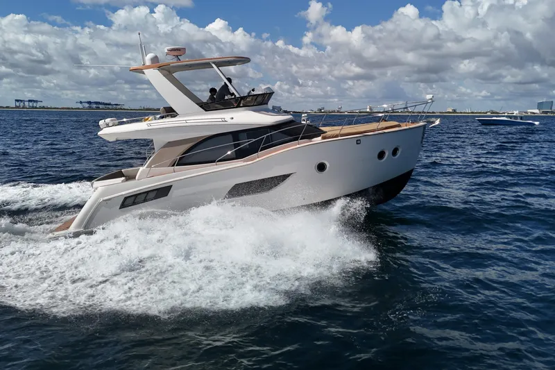  Yacht Photos Pics 2014 Carver 40 Command Bridge yacht cruising on open water under a cloudy sky.