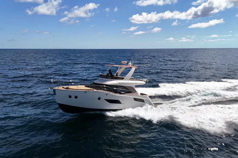  Yacht Photos Pics 2014 Carver 40 Command Bridge yacht cruising on open sea under blue sky.