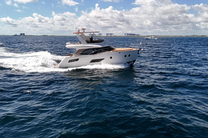  Yacht Photos Pics 2014 Carver 40 Command Bridge yacht cruising on open water under a partly cloudy sky.