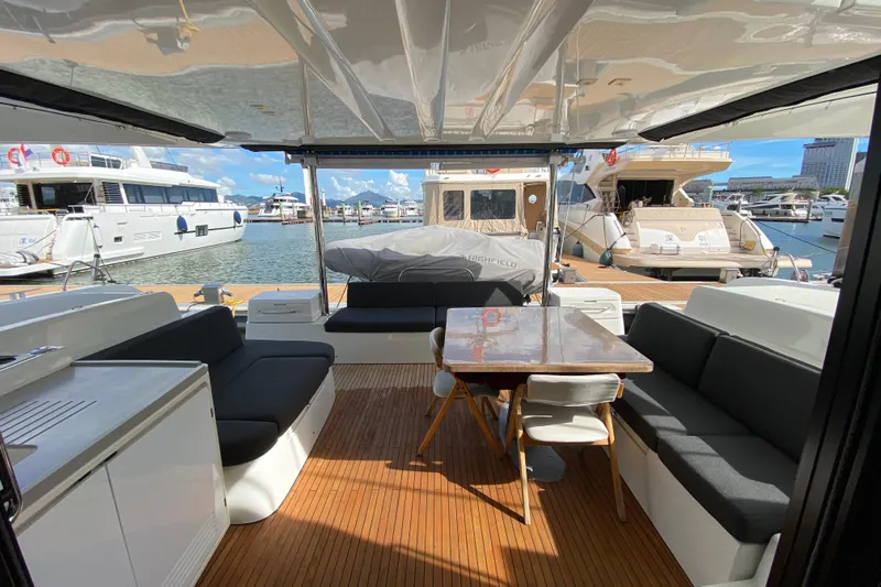  Yacht Photos Pics Spacious 2022 Lagoon 50 yacht interior with seating and dining area at marina.