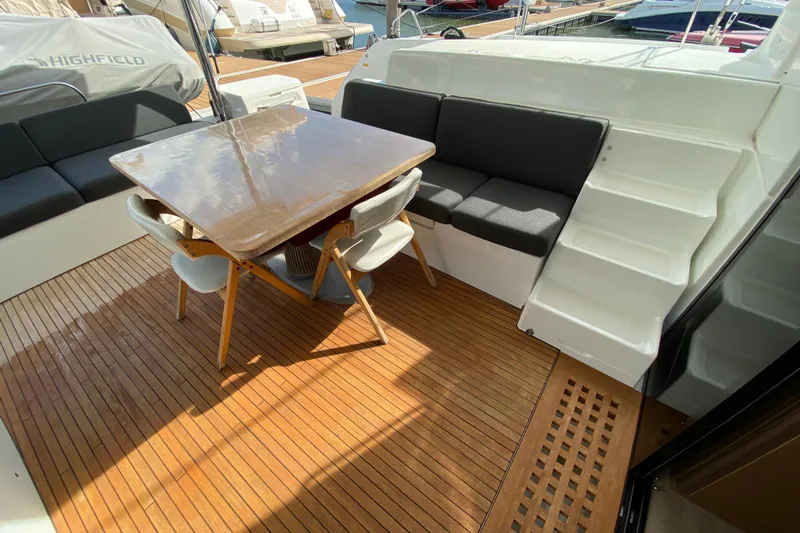  Yacht Photos Pics Outdoor seating area on 2022 Lagoon 50 yacht with wooden deck and modern furniture.