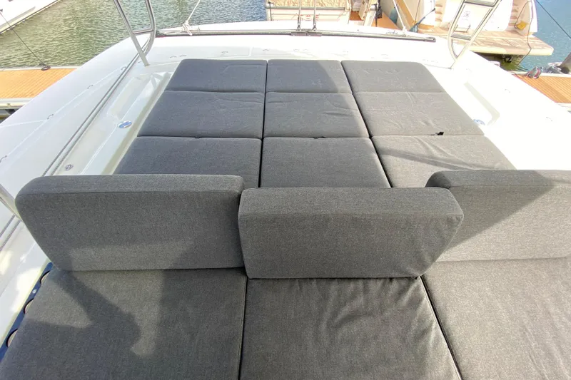  Yacht Photos Pics Luxurious sunbathing area on 2022 Lagoon 50 catamaran with comfortable gray cushions.