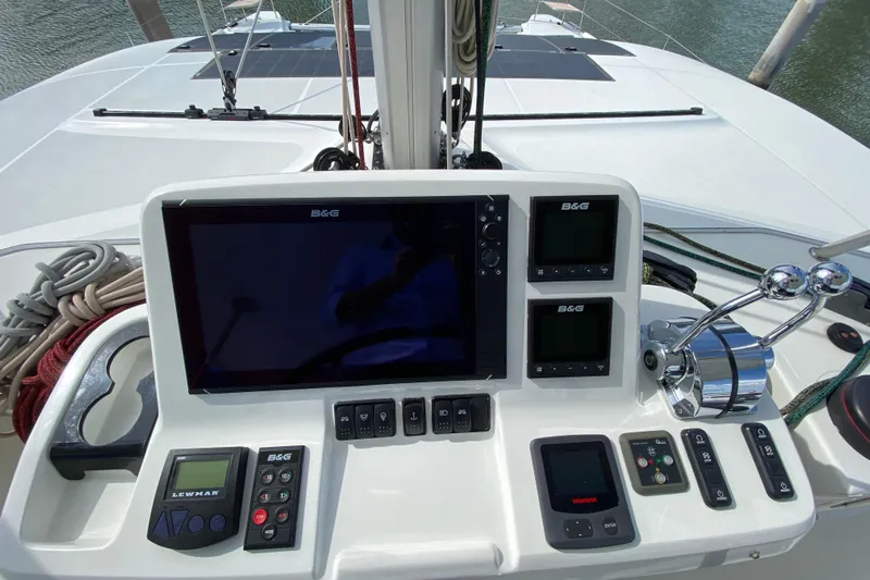  Yacht Photos Pics Control panel of a 2022 Lagoon 50 catamaran with navigation and throttle controls.